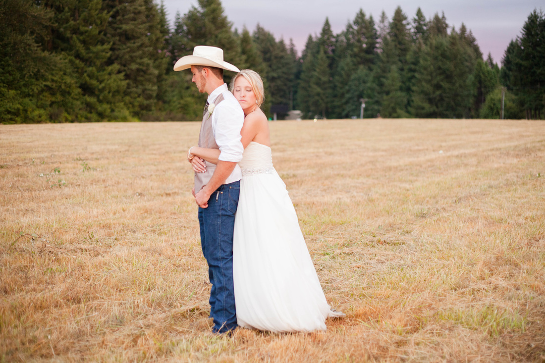 Country Wedding in a field at sunset with cowboy hat Hillsboro Wedding Photographer