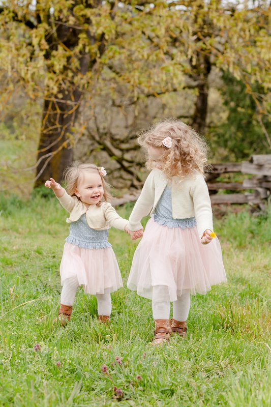 Family portrait of two girls in tulle dresses and cowboy boots at Champoeg State Park near Sherwood, Oregon | Newberg family photographer