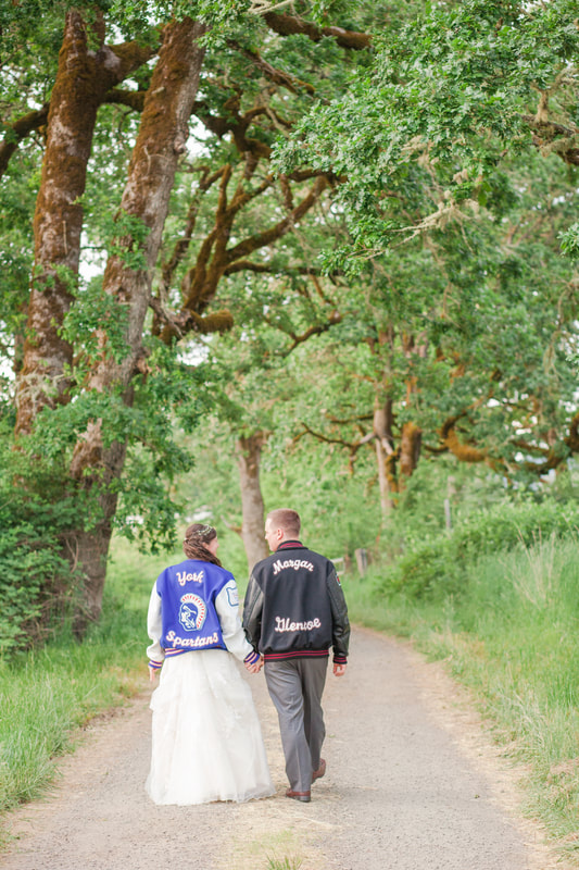 bride and groom in letterman jackets at Carlton Hill Vineyards wedding in Yamhill County Oregon Wine County | Hillsboro Wedding Photographer