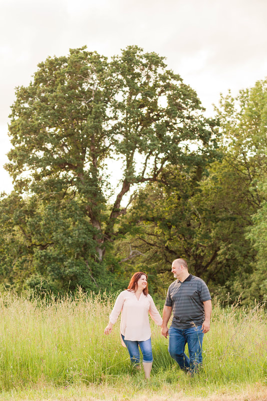 engagement photos in a field at champoeg state park in newberg, oregon | hillsboro wedding photographer