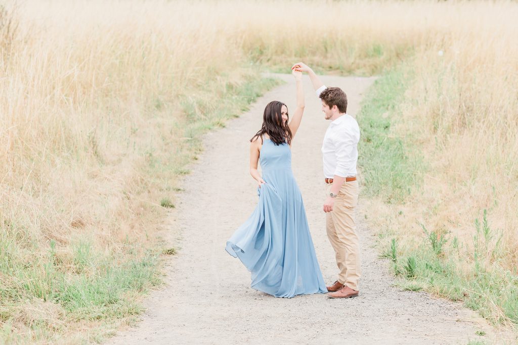 flowy blue dress engagement photos in a field