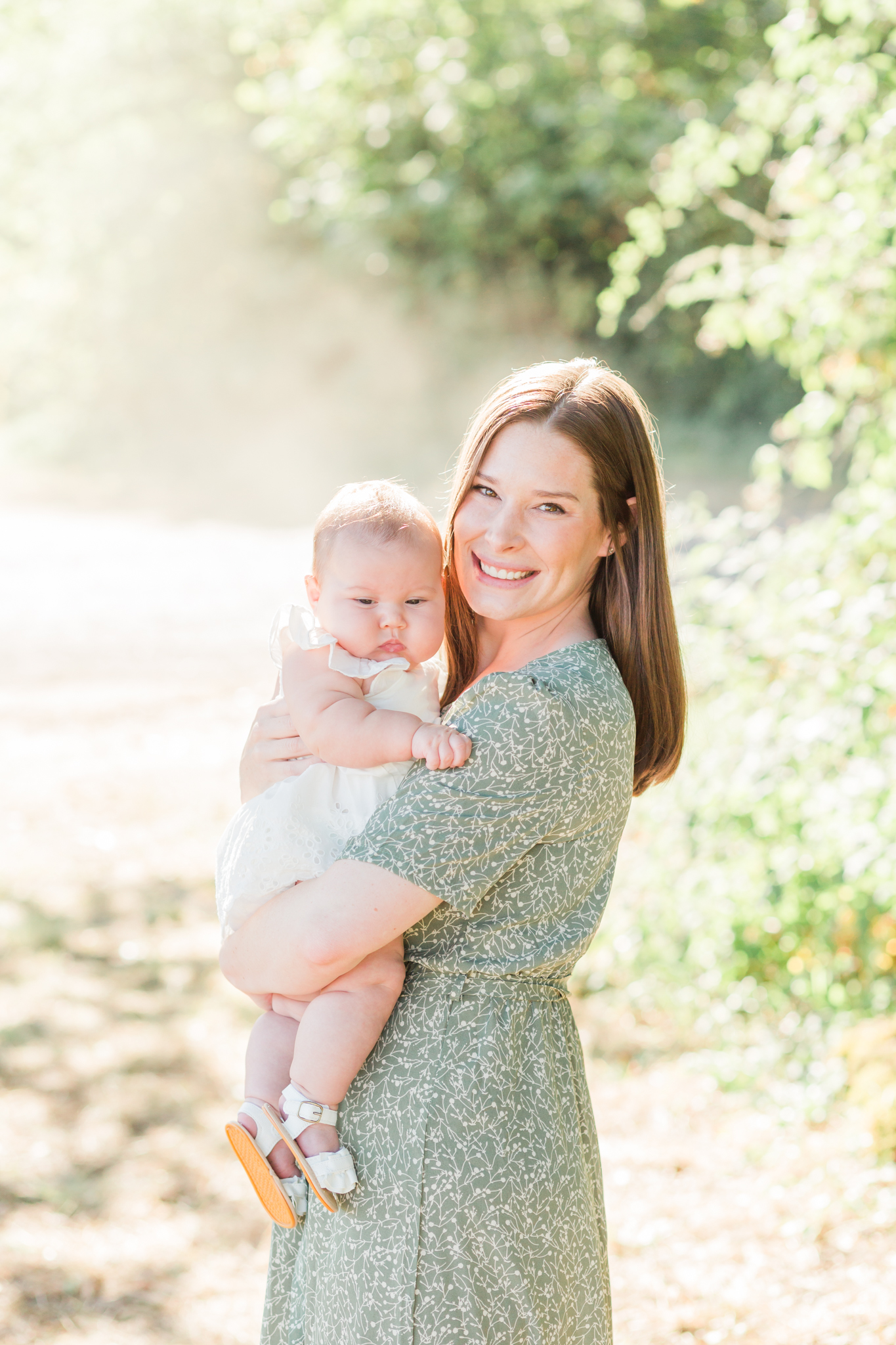 mom holds baby in a light and airy family photo session