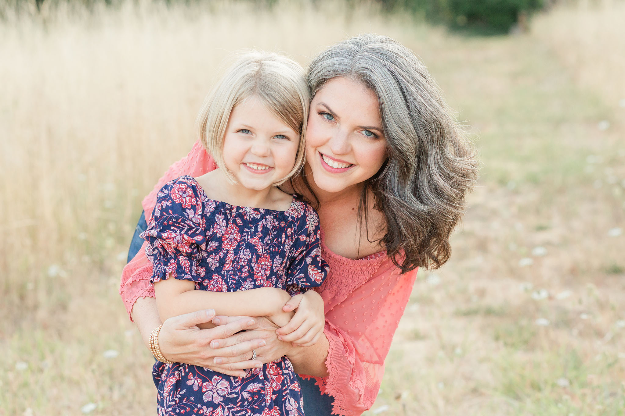 family photo of mom and daughter in a field