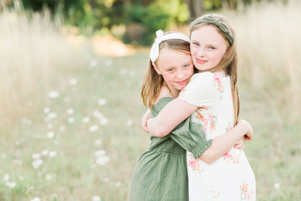 two girls hug at a sisters photoshoot