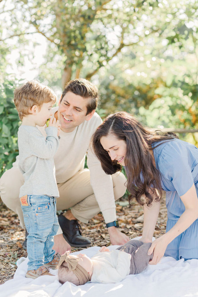 family of four in the orchard at luscher farm for lake oswego photos