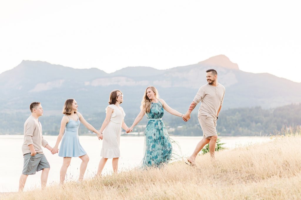 family of 5 walking with mountains in the background