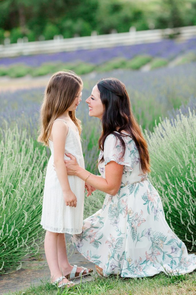 mom kneeling in front of daughter at lavender field family photos