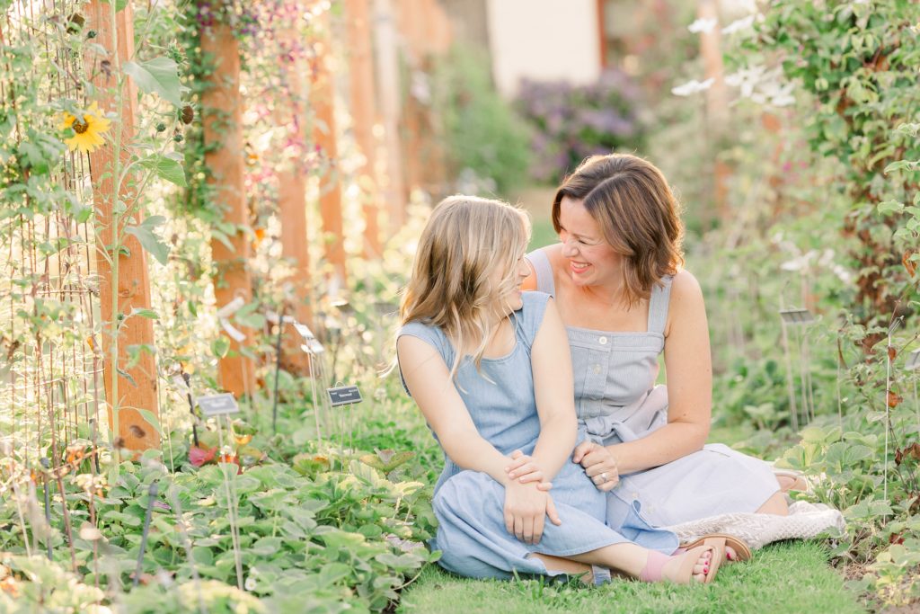 mom and daughter in a garden for family photos in Portland, Oegon