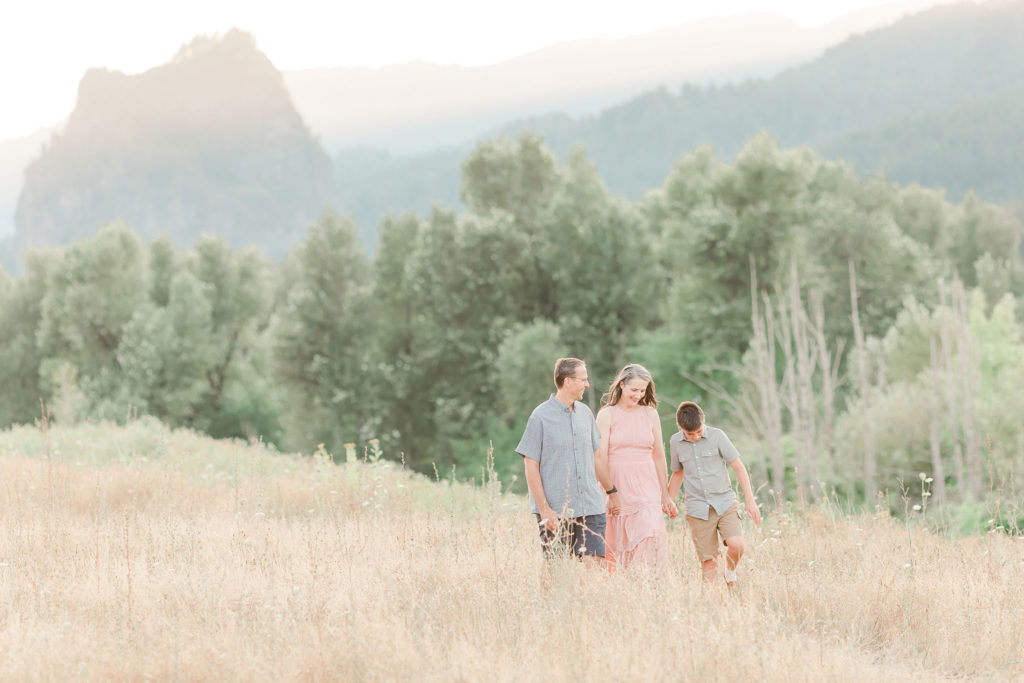 family of three walking in front of Beacon Rock for a lifestyle photography session near Portland, Oregon