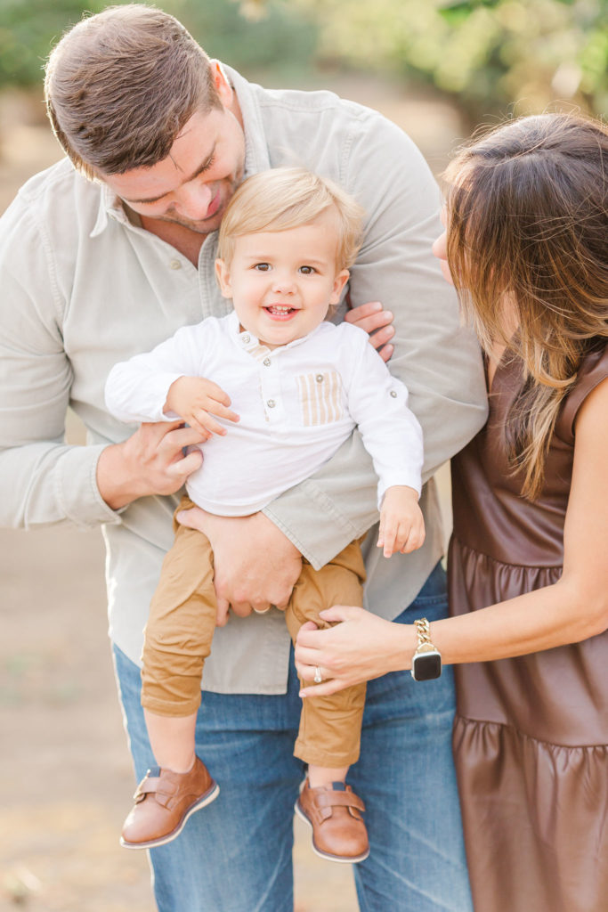 family of 3 in hazelnut orchard by Portland portrait photographers Samantha Shannon