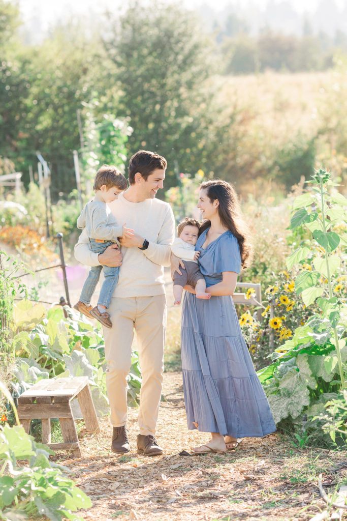 family of four walking through a flower field