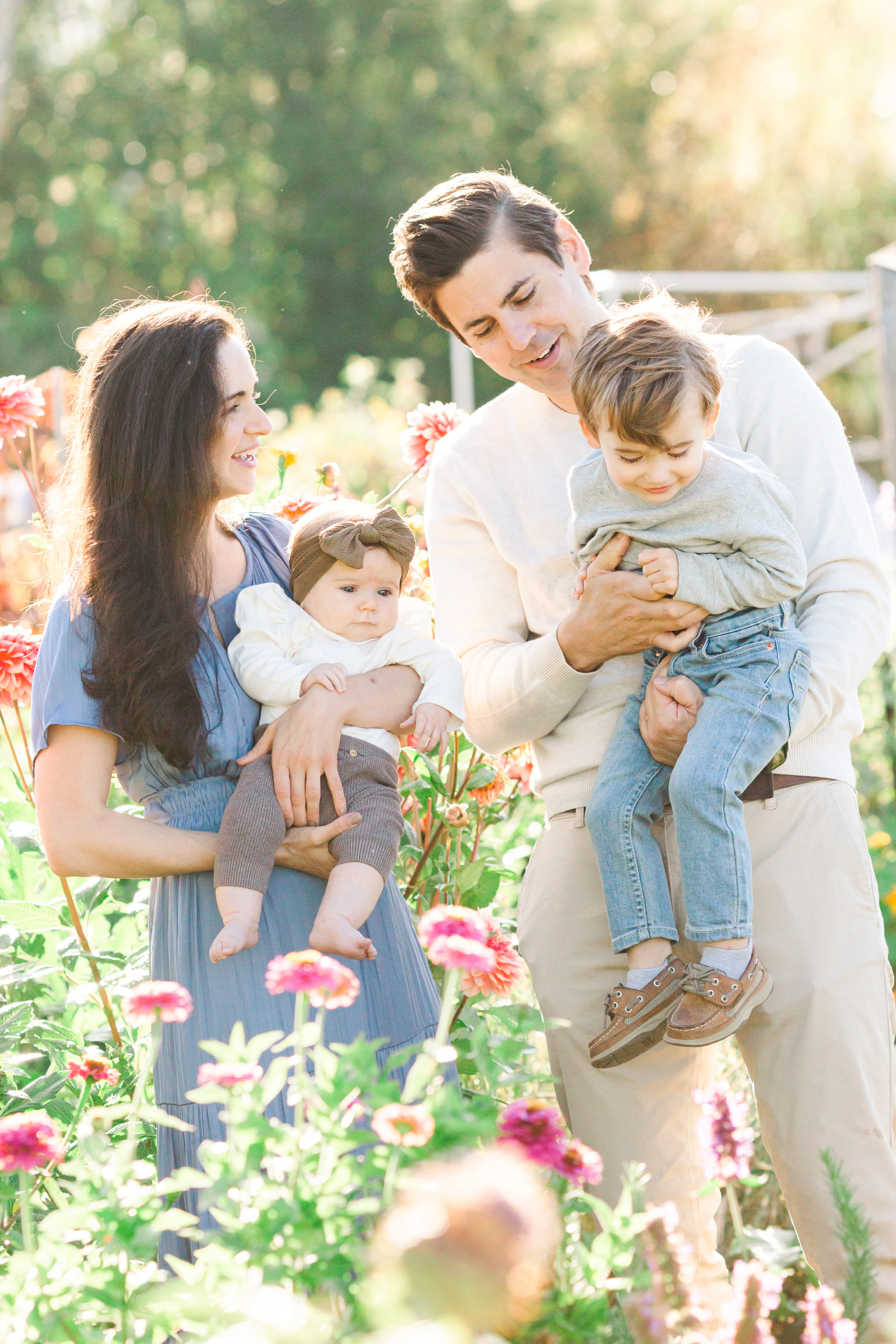 family of four standing in a flower field by vancouver wa photographer samantha shannon