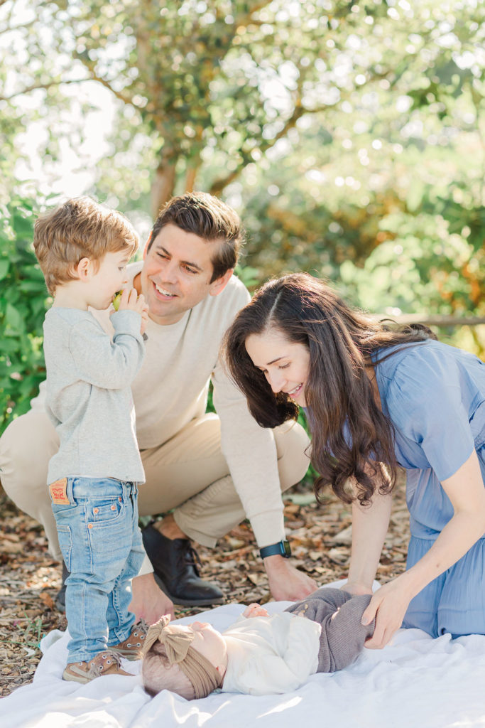 family of four in an apple orchard for photos by photographer in vancouver wa samantha shannon