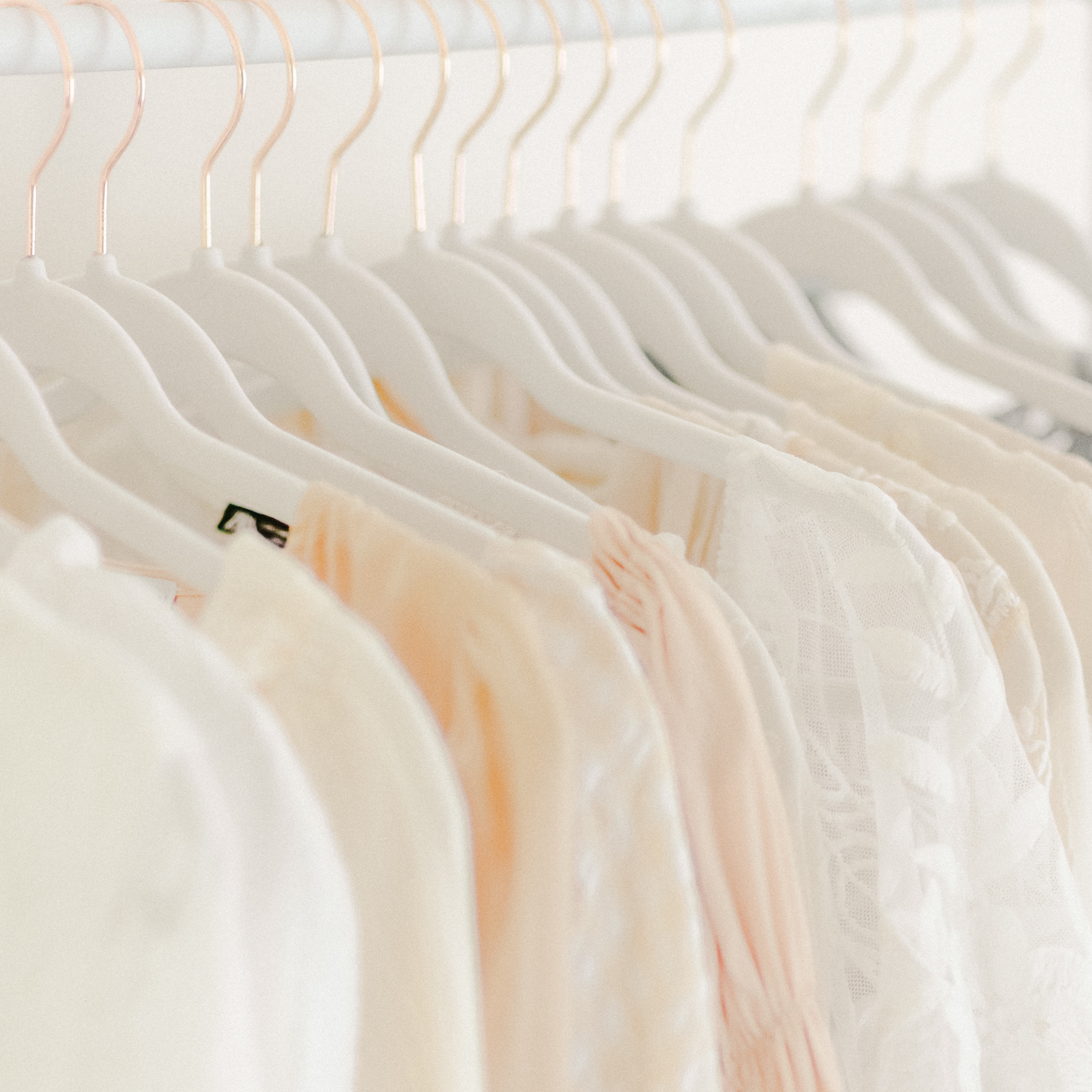 dresses hanging in a client closet: essential questions to ask before hiring a photographer