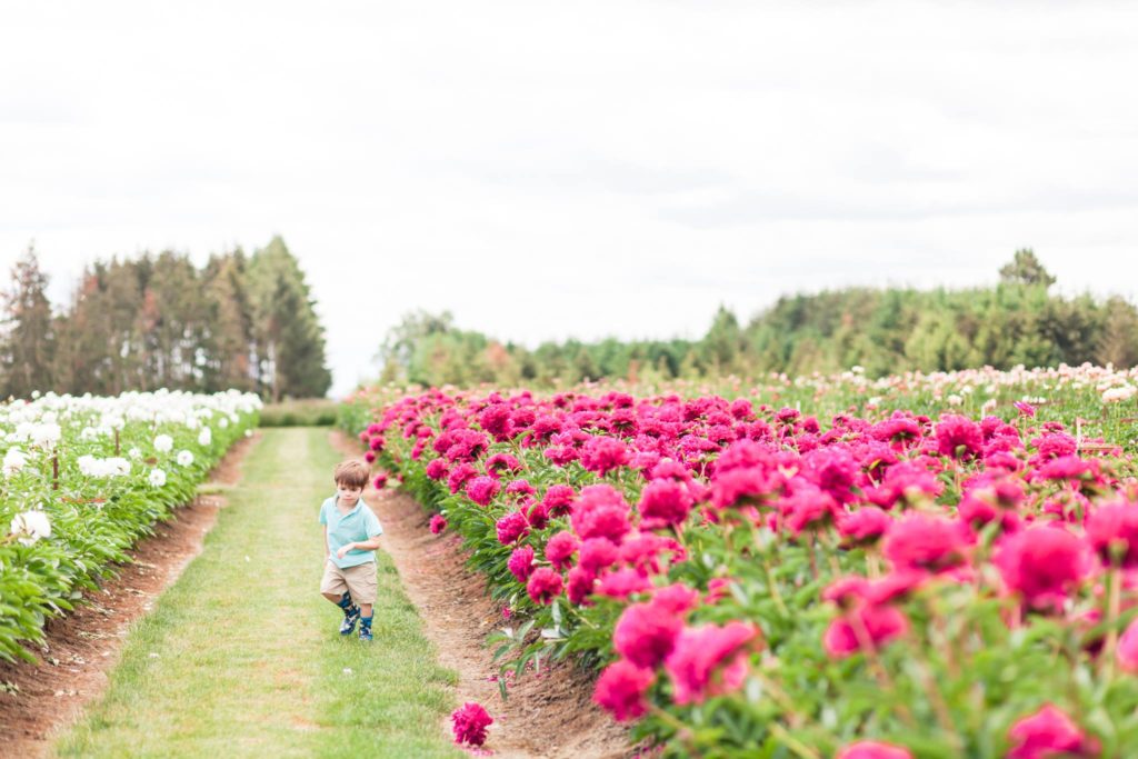 child running through flower field near portland oregon