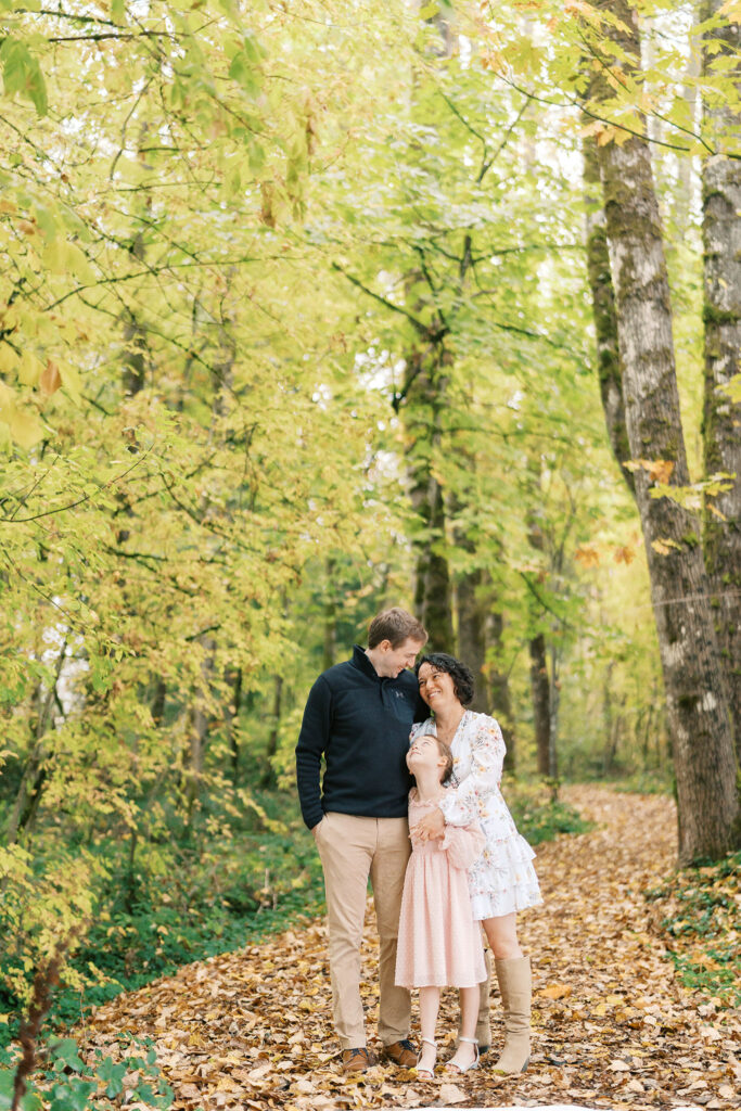 family of 3 in forest during fall
