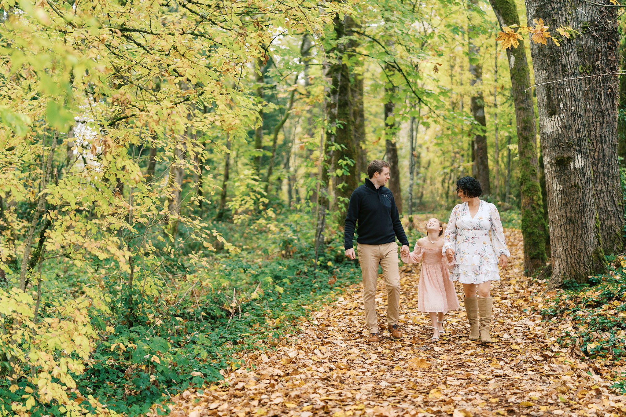 family walks through forest path during forest family photos near portland oregon